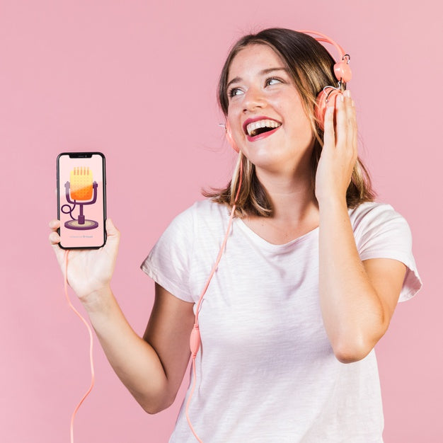 Laughing Young Woman With Headphones Holding A Cellphone Mock-Up Psd