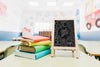 Little Blackboard Mock-Up Next To Colorful Books Psd