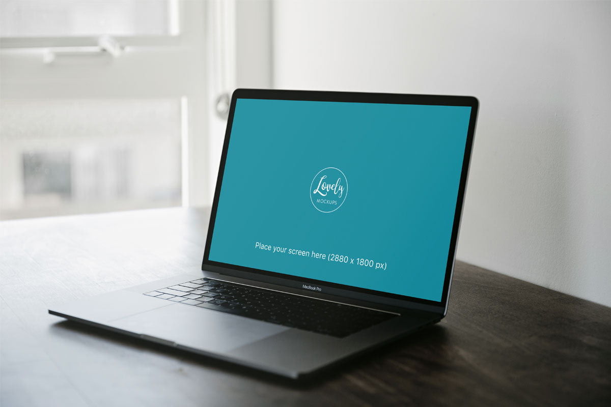 Space Grey Macbook Mockup Pro On A Brown Table