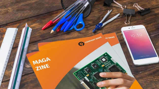 Magazine And Smartphone Mockup On Wooden Table With Pens And Rulers Psd