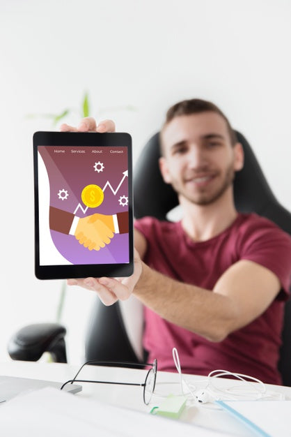 Male Student At Desktop Holding Tablet Psd
