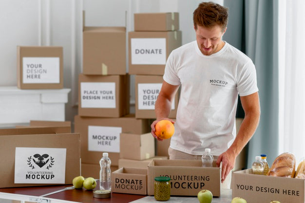 Male Volunteer Preparing Donation Box With Provisions Psd