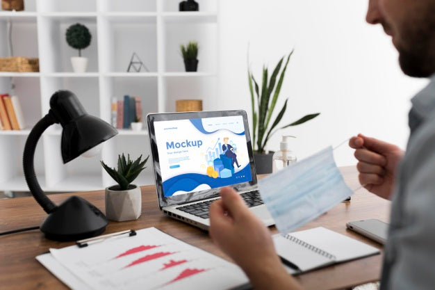 Man At Desk With Mask And Laptop Mock-Up Psd