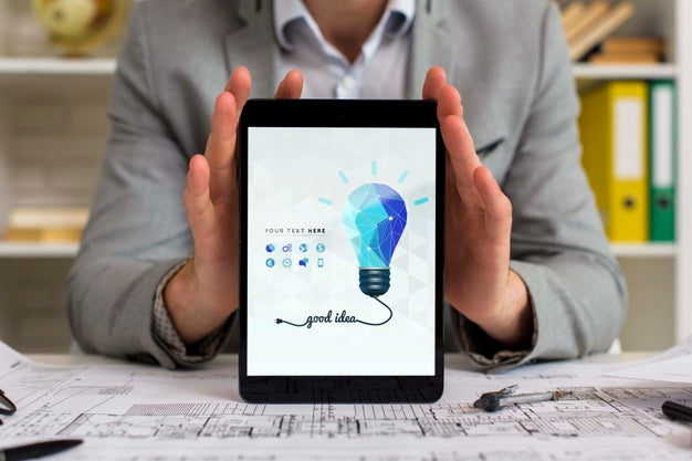 Man At His Office Desk Holding Digital Tablet Psd