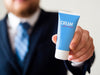 Man Holding A Hand Cream Bottle For Man Mock-Up Psd