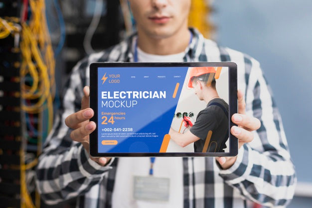 Man Holding A Mock-Up Tablet At Work Psd