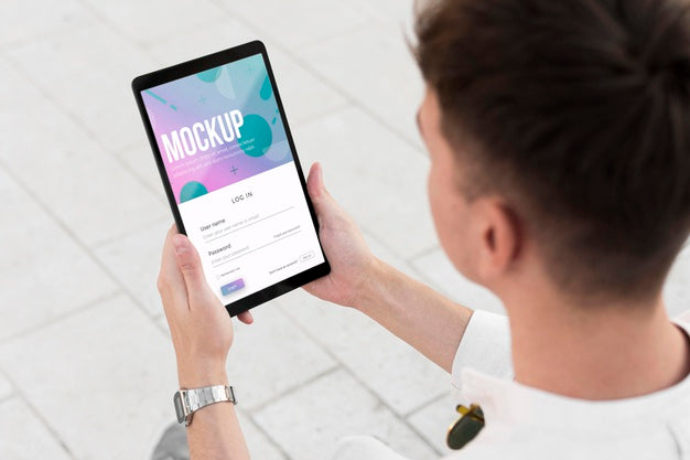 Man Holding A Mock-Up Tablet Outside Psd