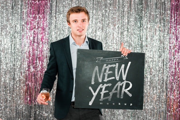 Man Holding Blackboard For New Year Psd