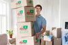 Man Holding Boxes With Objects In His New House Psd