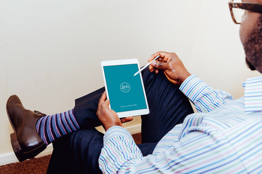 Man Typing on an White iPad Mockup