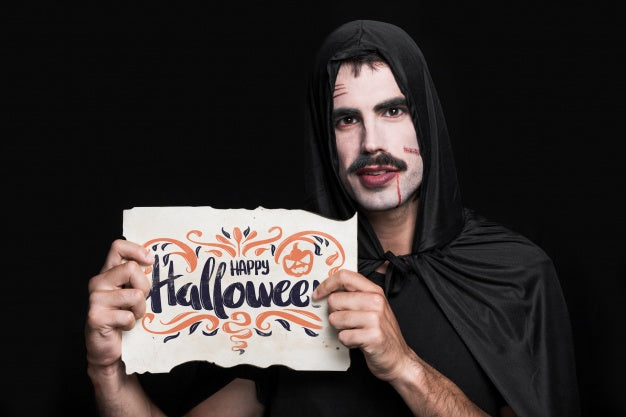 Man Holding Paper With Halloween Lettering Psd