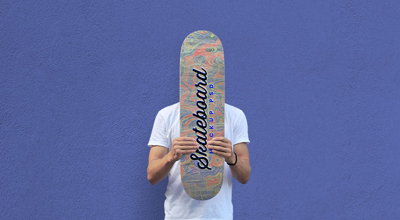 Man Holding Skateboard Mockup Psd