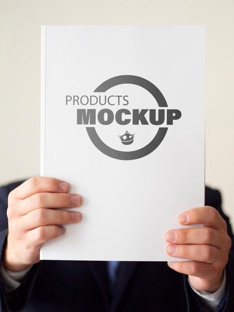 Man Holding Up A Notebook Mock-Up Psd