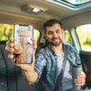 Man In Car Showing Smartphone Mockup Psd
