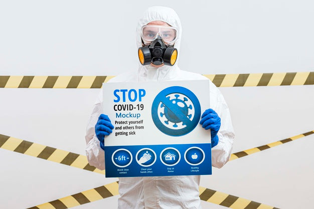 Man In Hazmat Suit Holding A Stop Coronavirus Mock-Up Psd