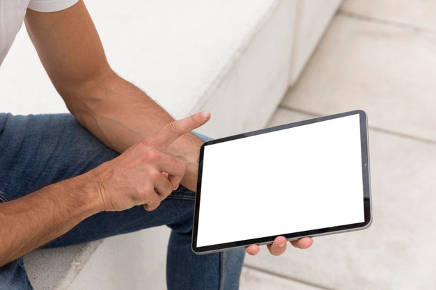 Man On Street With Tablet Reading Online Psd