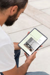 Man On Street With Tablet Reading Online Psd