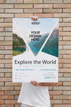 Man Presenting Poster Mockup In Front Of Brick Wall Psd