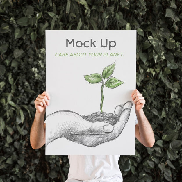 Man Presenting Poster Mockup In Front Of Leaves Psd