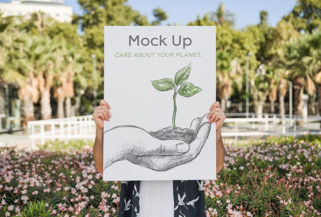 Man Presenting Poster Mockup In Front Of Park Psd