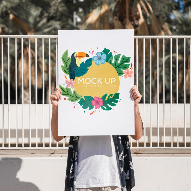Man Presenting Poster Mockup In Front Of Park Psd