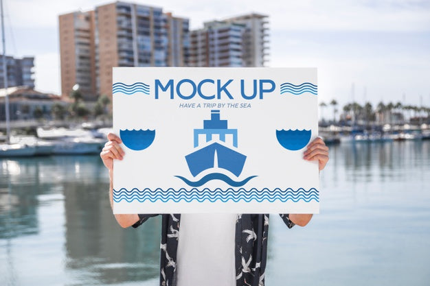 Man Presenting Poster Mockup In Front Of Water Psd