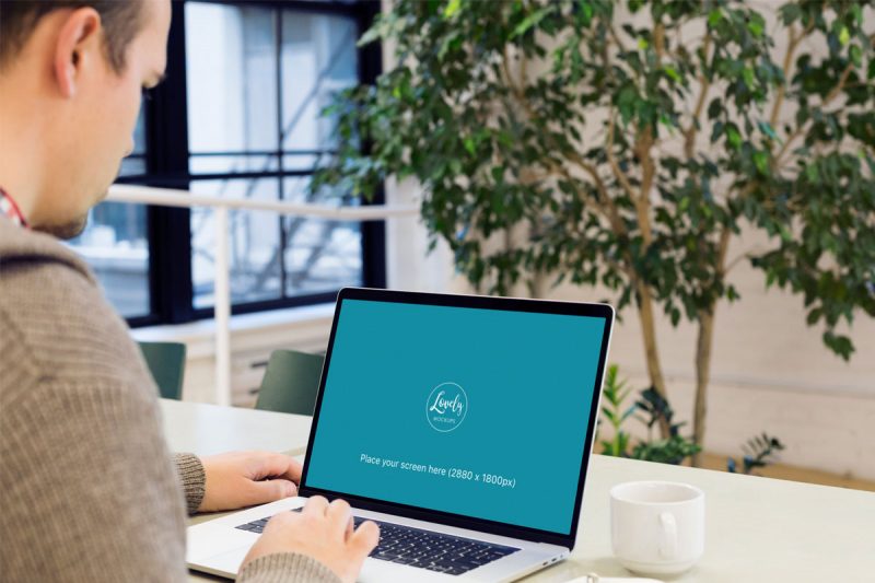 Man Working on a Macbook pro Mockup