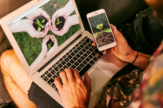 Man Using Laptop And Smartphone Mockup With Nature Concept Psd