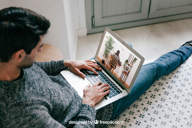 Man Using Laptop At Home Psd