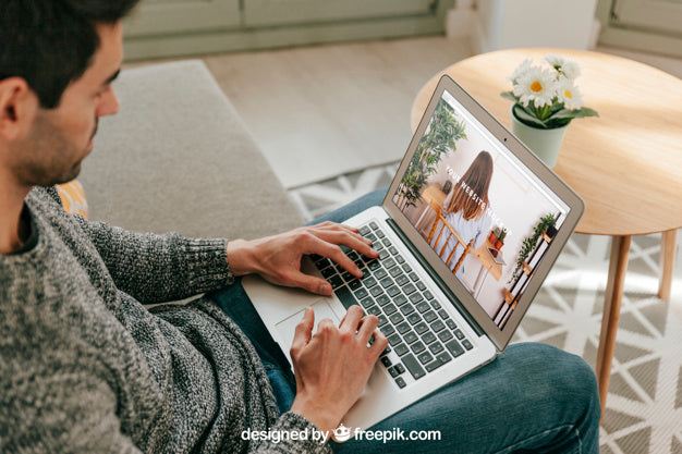 Man Using Laptop In Living Room Psd