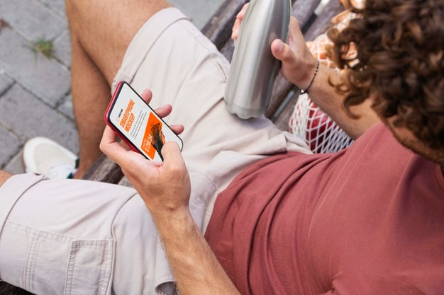 Man Using Mock-Up Smartphone Outdoors Psd