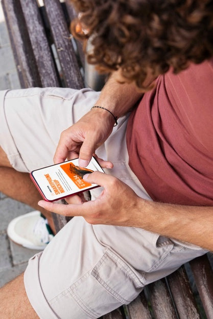 Man Using Mock-Up Smartphone Outdoors Psd