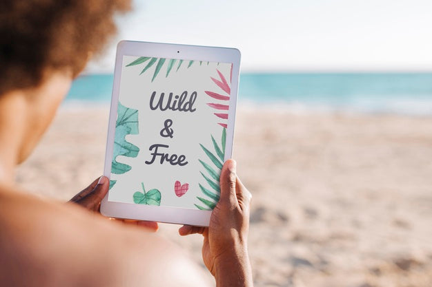 Man Using Tablet Mockup At The Beach Psd