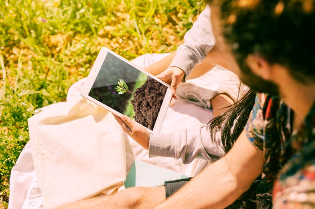 Man Using Tablet Mockup In Nature Psd