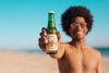 Man With Beer Bottle Mockup At The Beach Psd