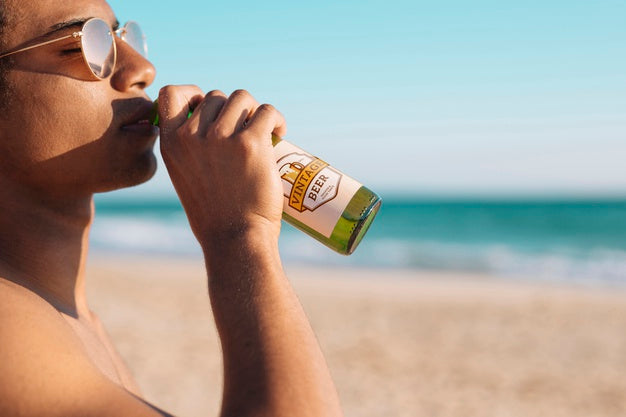 Man With Beer Bottle Mockup At The Beach Psd