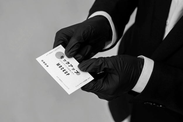 Man With Gloves Holding A Business Card Mock-Up Psd