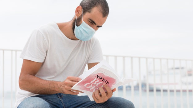 Man With Mask On Street Reading Book Psd