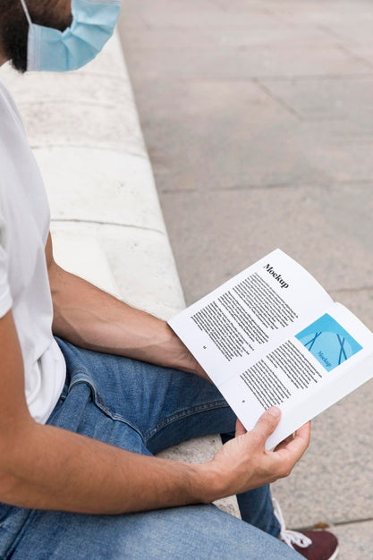 Man With Mask On Street Reading Book Psd