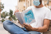 Man With Mask On Street Reading Book Psd
