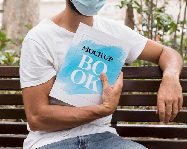 Man With Mask On Street Reading Book Psd