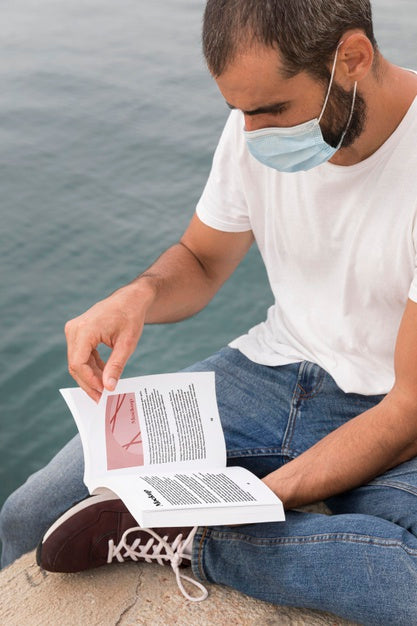 Man With Mask On Street Reading Book Psd