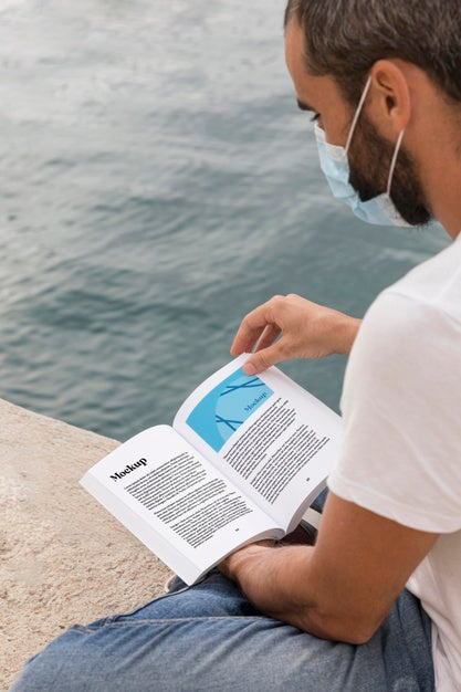 Man With Mask On Street Reading Book Psd