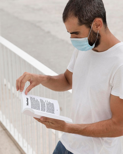 Man With Mask On Street Reading Book Psd