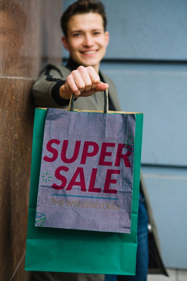 Man With Shopping Bags In City Psd