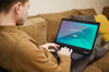 Man Working On Laptop From Home While Sitting On The Couch Psd