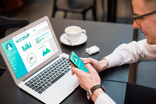 Man Working On Smartphone And Laptop Psd