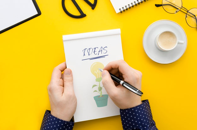 Man Writing On Notebook Mock-Up At Desk Psd