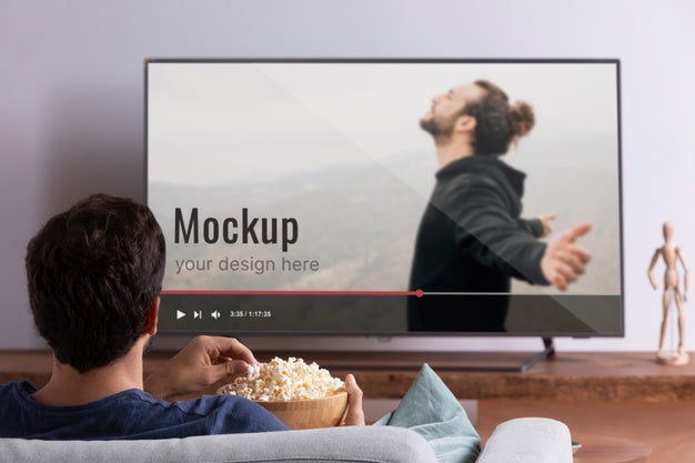 Medium Shot Man Watching Movie On Tv Psd