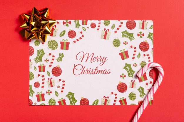 Merry Christmas Mock-Up Paper With Sugar Cane And Bow Psd